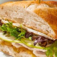 Oven-Roasted Turkey + Brie Sandwich · With shaved Granny Smith apple, spring mix and housemade honey-mustard.