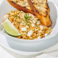 Mexican Street Corn · Roasted with smoked paprika, Feta and Parmesan. Served with fresh cilantro, lime, housemade ...