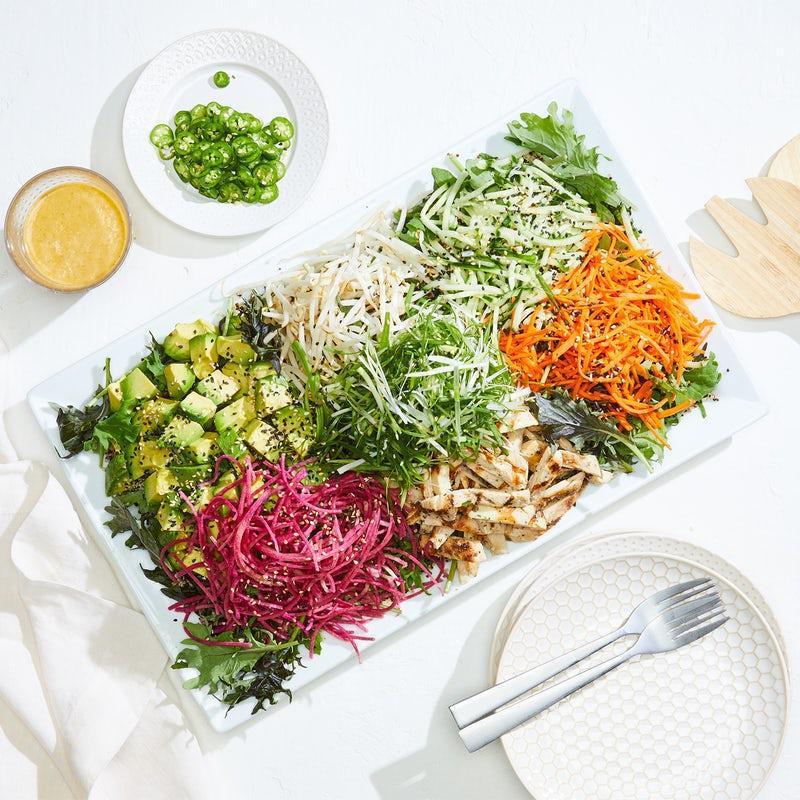 Catering Banh Mi Bowl · Quinoa, baby kale, fresh cilantro & mint topped with grilled chicken, watermelon radish, fresh avocado, cucumber, carrot, bean sprouts, scallions and sesame seeds. Served with housemade chili-lime vinaigrette and serrano peppers.