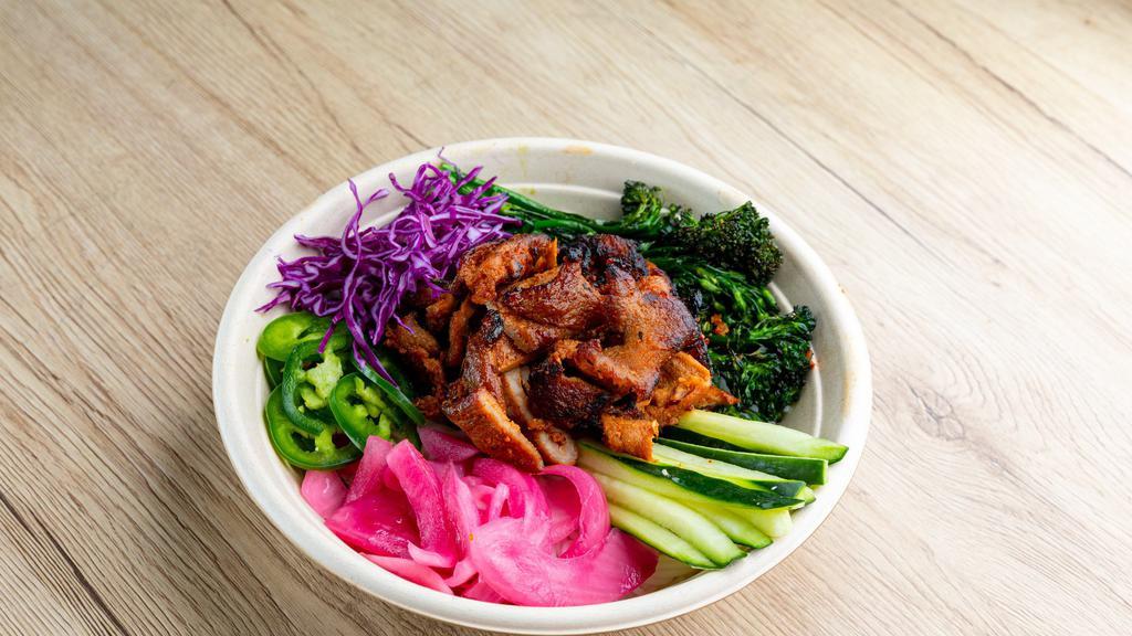 Bowl - Spicy Porker · Gochujang Spicy Pork, Pickled Onions, Cucumbers, Jalapenos, Roasted Broccolini, Purple Cabbage, Fried Shallots. Your choice of base and sauce.