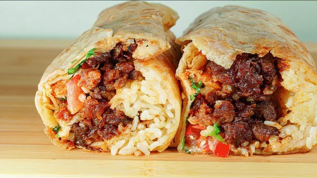 Tocino Burrito · Burrito wrapped in a 13.5 inch tortilla. Topped with rice, sour cream, cheese, onions, cilantro, tomatoes, and tocino.