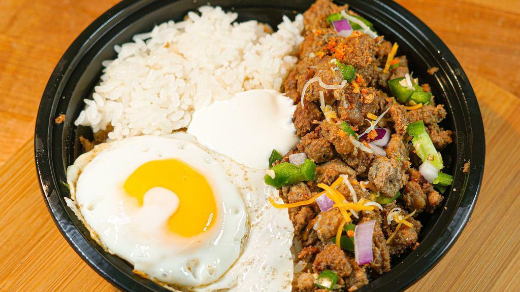 Sisig Rice Bowl w/ Egg · Rice bowl topped with sisig, sour cream, cheese, onions, jalapeños, and chicharron along with an egg