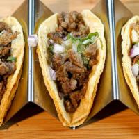 Bistek Tacos · Beef steak tacos topped with onions, cilantro and mild salsa Verde.