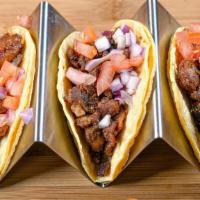 Tocino Tacos · Sweet, glazed pork topped with tomatoes pickled in vinegar and onions.