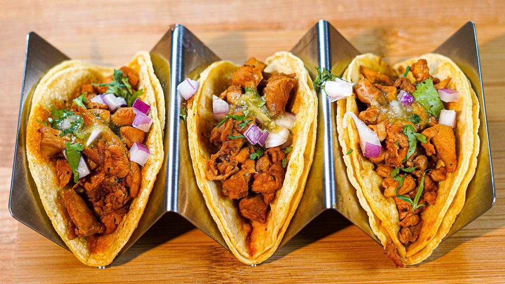 Lemon Pepper Chicken Adobo Tacos · Topped with onions, cilantro and mild salsa Verde.