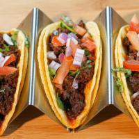 Longanisa Tacos · Sweet breakfast sausage topped off with onions and tomatoes pickled in vinegar.