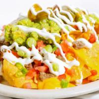 Chicken Nachos · A heaping pile of crisp homemade tortilla chips topped with chicken and smothered with our s...