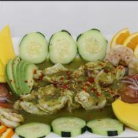 Botana Aguachile · Cooked shrimp with lemon juice, green sauce and chiltepin pepper.