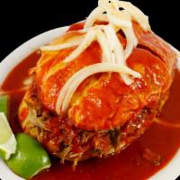 Torta Ahogada · A delicious piece of roll bread generously filled with homemade roasted pork, fried beans, t...