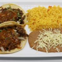 Double Soft Taco Combo · Two soft tacos, choice of meat, onion, cilantro, salsa, side of rice, and refried beans topp...