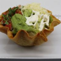  Taco Salad · Hard-shell tortilla bowl, filled with your favorite meat choice, refried beans, rice, cheese...
