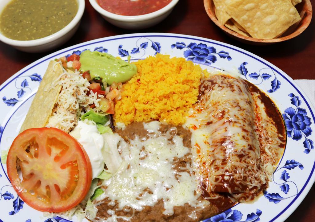  Combo Plate · One red enchilada and one crispy taco both filled with your choice of meat, served with salad, rice, fried beans, cheese, fresh guacamole, and sour cream.