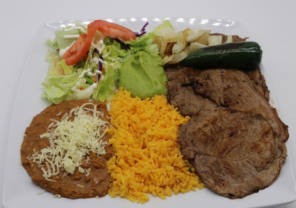 Carne Asada · Tender grilled steak ball tip beef lightly spiced, served with salad, refried beans, rice, fresh guacamole, and sour cream.
