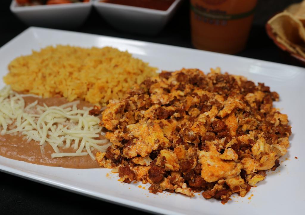 Huevos con Chorizo · Eggs and Chorizo, three eggs scrambled with tasty Mexican chorizo sausage served with rice, fried beans topped with cheese.