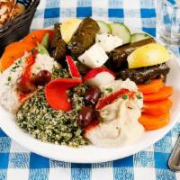 Large Combination Appetizer · Hummus, baba ghanoush, tabuleh, feta cheese, and dolma. Served with pita bread. Vegetarian.