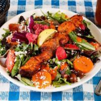 New! Grilled Salmon Salad  · Salmon marinated in a dill tomato sauce, skewered, grilled and served over organic mixed gre...