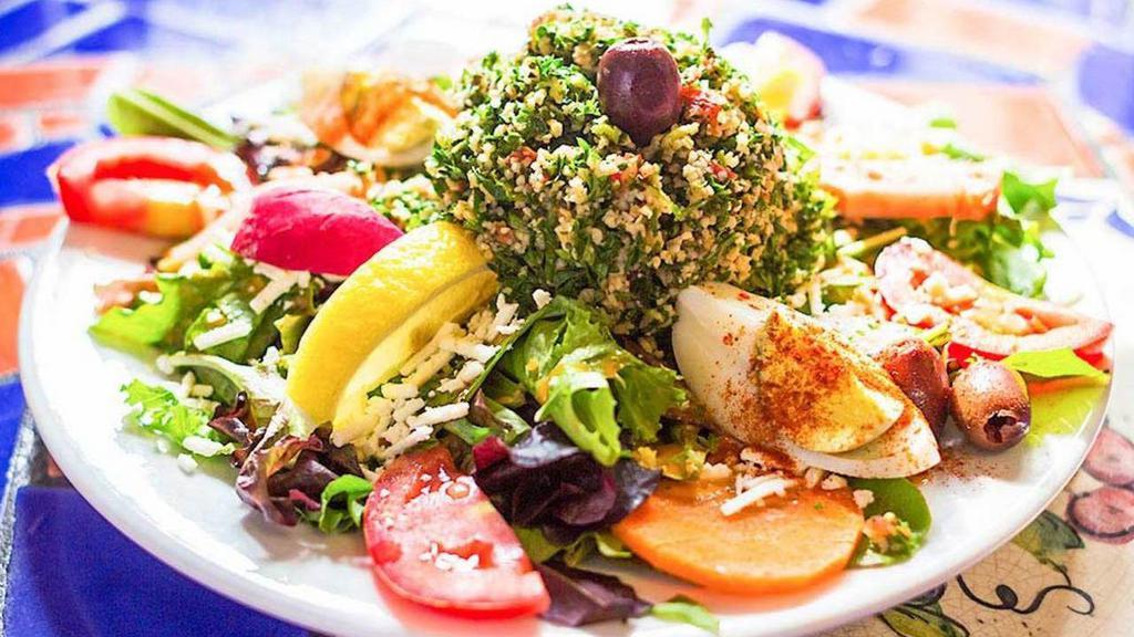 Large Green Salad · Gluten free, vegetarian, vegan. Organic mixed greens, cucumber, tomato, egg and a sprinkle of feta cheese, topped with tabuleh.