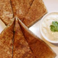 Personal Bolani · Fried flatbread stuffed with potato and fresh herbs. Served with green chutney sauce and yog...