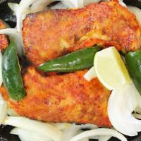 Tandoori Chicken · Two chicken legs seasoned in our house blend of spices. Served on hot plate with rice, naan ...