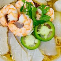 4. Seafood Noodles · Shrimp, calamari, fishcake garnished with green onions, cilantro, and fried garlic. Choice o...