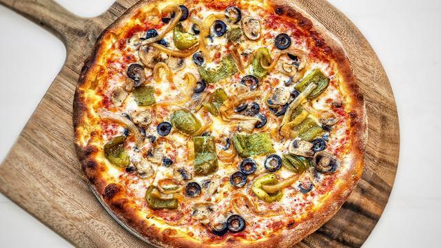 Veggie Pizza · Vegetarian. roasted green peppers, sautéed mushrooms, caramelized onions, black olives, and tomato sauce.