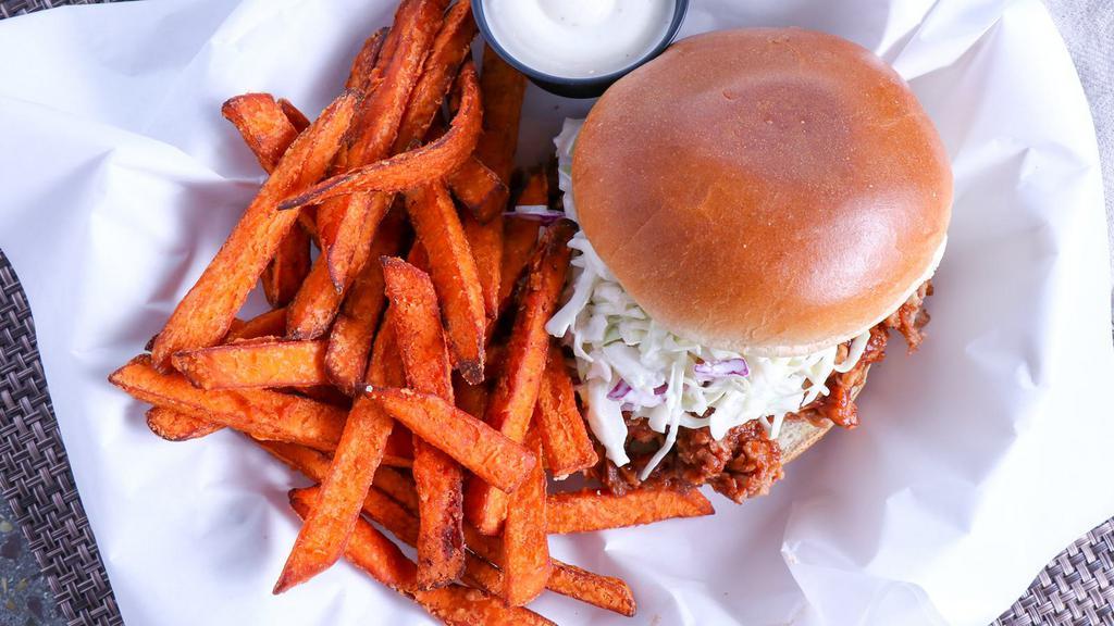 Pulled Pork Sandwich · Topped with coleslaw and served with sweet potato fries.