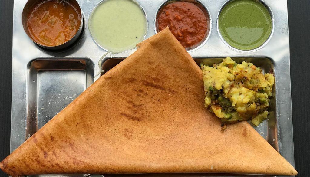 Masala Dosa · South Indian crepe delicacy made with rice flour and Lentil batter stuffed with mashed potatoes and served with Chutneys and Sambar