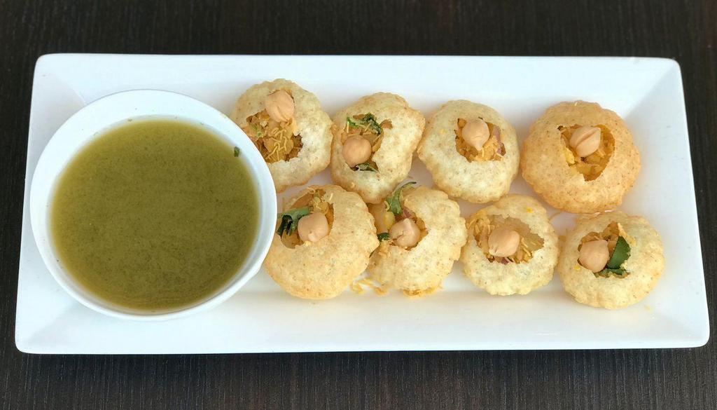 Pani Puri · Crispy puff wafers served with special masala water, onions and garbanzo beans.