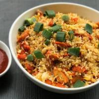 Schezwan Vegetable Fried Rice · Stir-fry the cooked rice, chicken, onion, garlic and mixed vegetables with schezwan and soy.