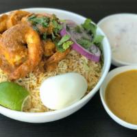 Shrimp Biryani · Special flavored basmati rice layered with shrimp tossed in a spicy sauce and served with ra...