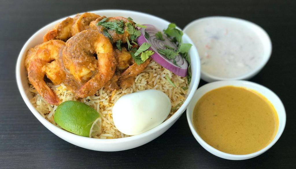 Shrimp Biryani · Special flavored basmati rice layered with shrimp tossed in a spicy sauce and served with raita and salan