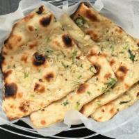 Garlic Naan · White flour (All purpose four) bread baked in tandoori oven and glazed with butter and chopp...