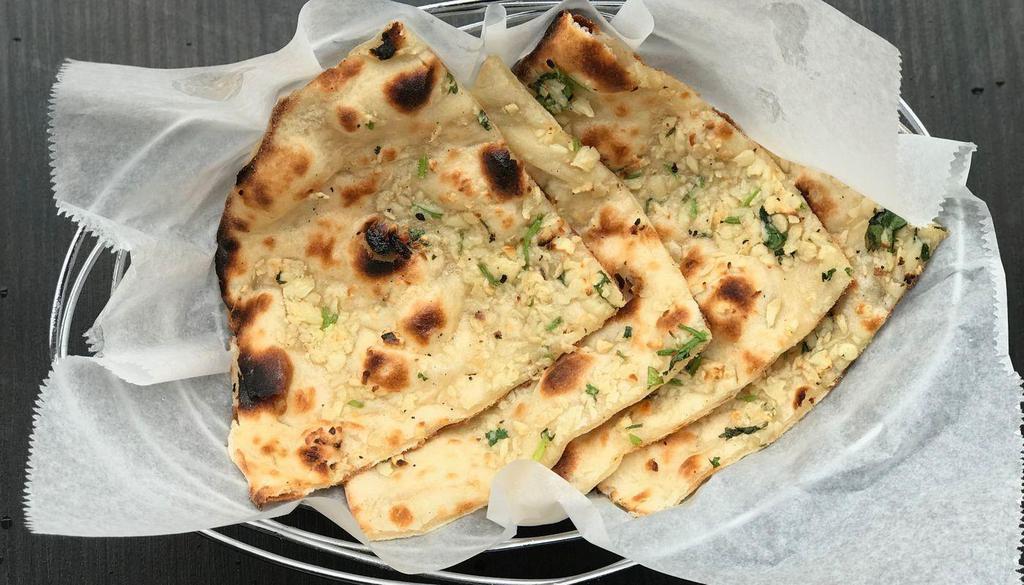 Garlic Naan · White flour (All purpose four) bread baked in tandoori oven and glazed with butter and chopped garlic