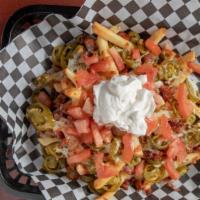 Nacho Fries · Delicious French Fries Topped with Bacon, Jalapeños, Cheese, Chopped Tomatoes and Sour Cream