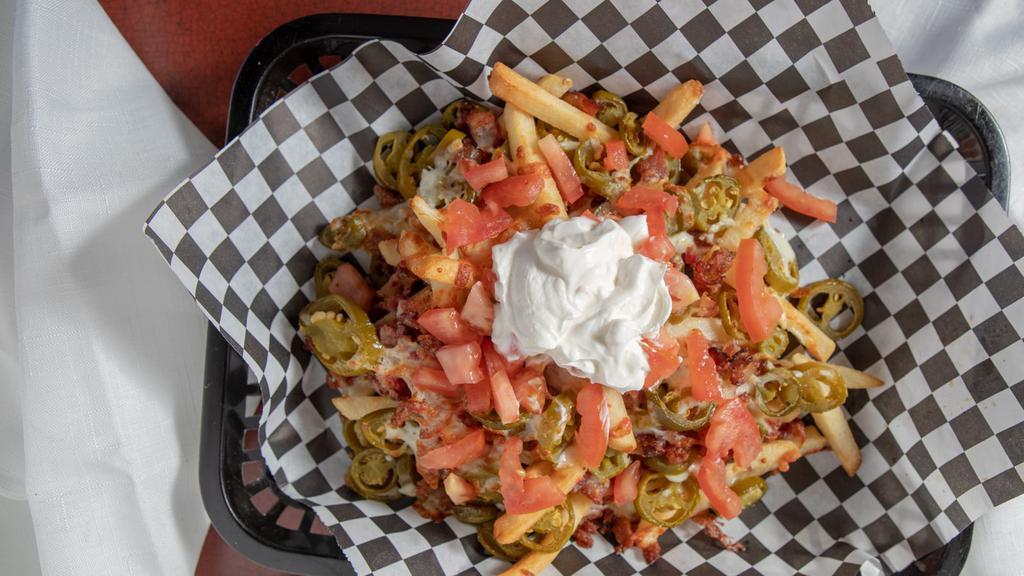 Nacho Fries · Delicious French Fries Topped with Bacon, Jalapeños, Cheese, Chopped Tomatoes and Sour Cream
