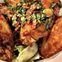 Sizzle Chicken Wings · Crispy wings tossed in house special sauce with fresh basil leaves.