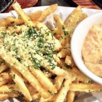 Parmesan Loaded Cheese Fries · Fries smothered in parmesan cheese topped with parsley and house aioli sauce on the side.
