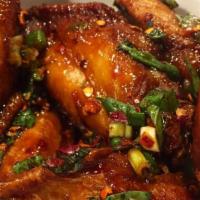 Sesame BBQ Wings · Crispy wings tossed in house BBQ sauce topped with sesame seeds.