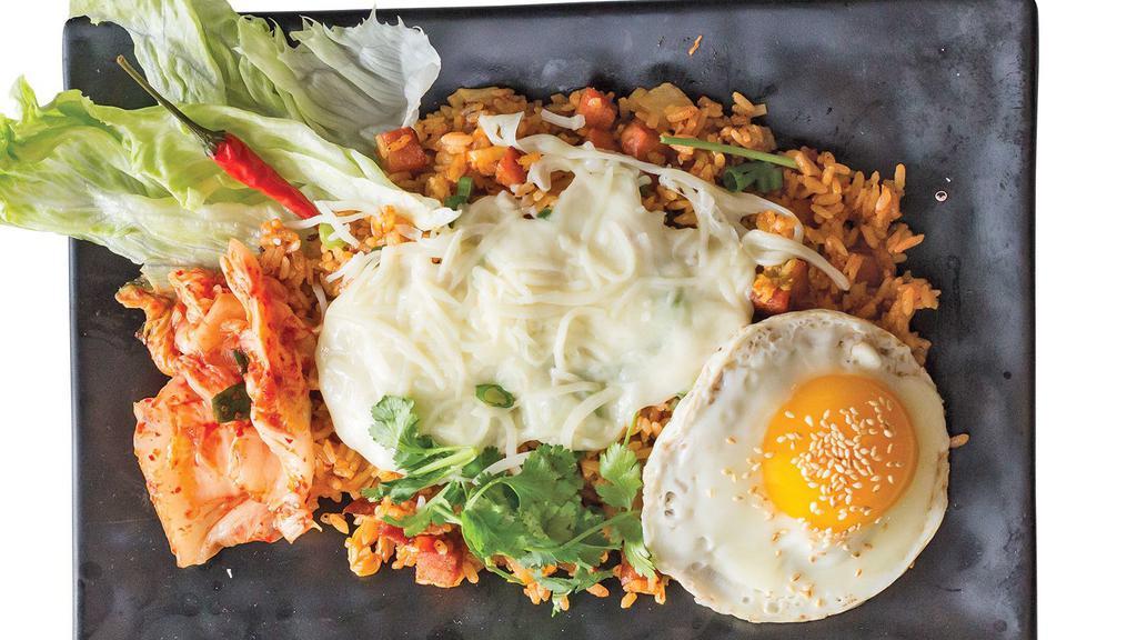Kimchi Fried Rice · Spicy. Rice fried with kimchi, spam, and green onions. Topped with mozzarella cheese and fried egg with sesame seeds.