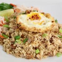 Sisig Fried Rice · Chicken or pork sisig fried rice served with a fried egg and side of pickled vegetables.