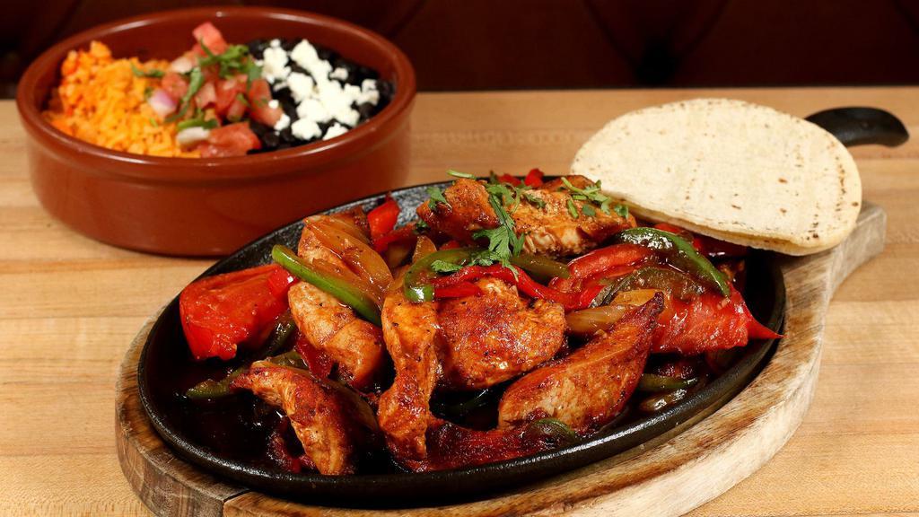Fajitas · Gluten-free. With tomatoes, onions, and bell peppers, served with tortillas, rice and beans.