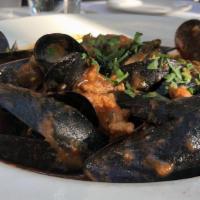 Mussels · Basil, white wine, and tomato broth.