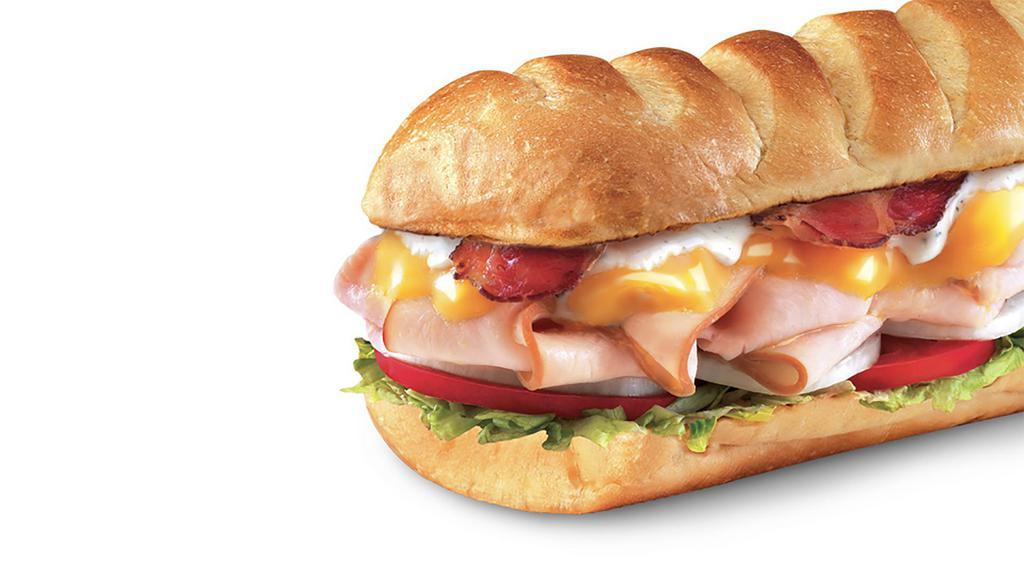Turkey Bacon Ranch ™, Large (11-12 Inch) · Smoked turkey breast, pepper bacon, sharp cheddar cheese topped with peppercorn ranch, mayo, lettuce, tomato, and onion.