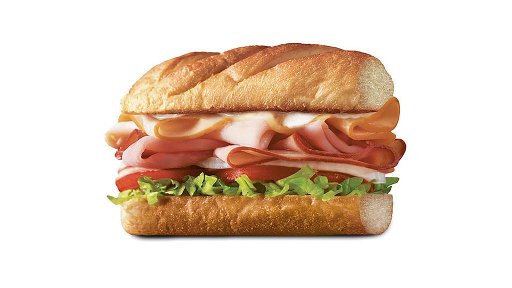 Club On A Sub™, Medium (7-8 Inch) · Smoked turkey breast, Virginia honey ham, crispy pepper bacon, and melted Monterey Jack, served Fully Involved® (mayo, lettuce, tomato, onion, deli mustard, and a pickle spear on the side).