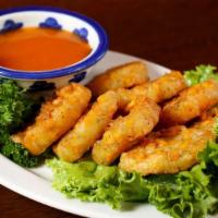 Tod Mun Kao Pohd · Vegetarian. Deep-fried corn cakes served with plain sauce.