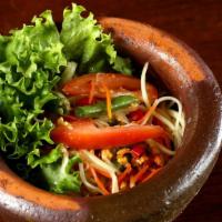 Som Tum Salad · Vegetarian. Spicy. Shredded green papaya salad with carrots, tomatoes, green beans and groun...