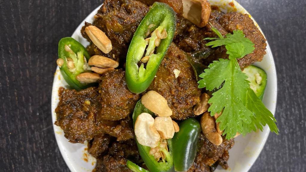 Rayalaseema Goat Vepudu- Extra Spicy · Marinated bone in goat pieces cooked in slow flame with rich Indian herbs and pan fried with masala. Served with onions, lemons.