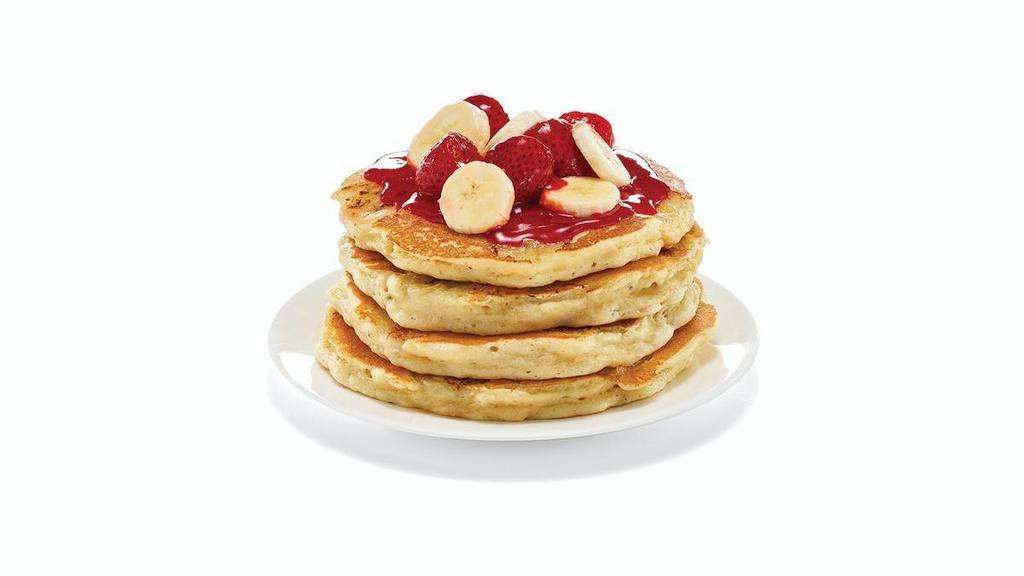 Strawberry Banana Protein Pancakes · A fresh-flipped power stack. Four protein pancakes filled with fresh banana slices. Topped with glazed strawberries & more banana slices.