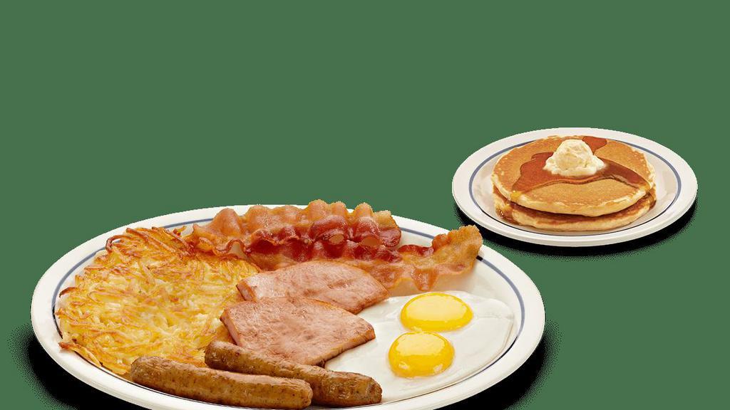 Breakfast Sampler · Two eggs* your way, 2 custom cured hickory-smoked bacon strips, 2 pork sausage links, 2 thick-cut pieces of ham, golden hash browns & 2 fluffy buttermilk pancakes. .