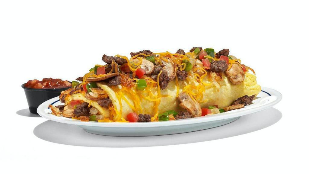 Big Steak Omelette · Your hunger won’t be at steak with this one. Our omelette+ stuffed with steak, hash browns, green peppers, onions, mushrooms, tomatoes & Cheddar cheese. Served with our salsa.